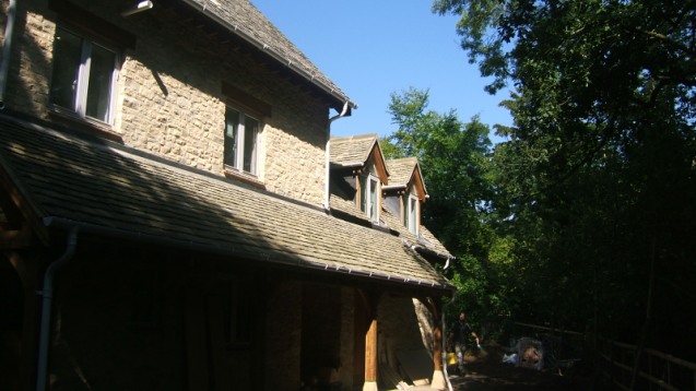 Tiled roof with dormers on a stone house